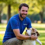 Mark, co-founder of PupGear Premium, playing fetch with his Terrier Mix, Pip